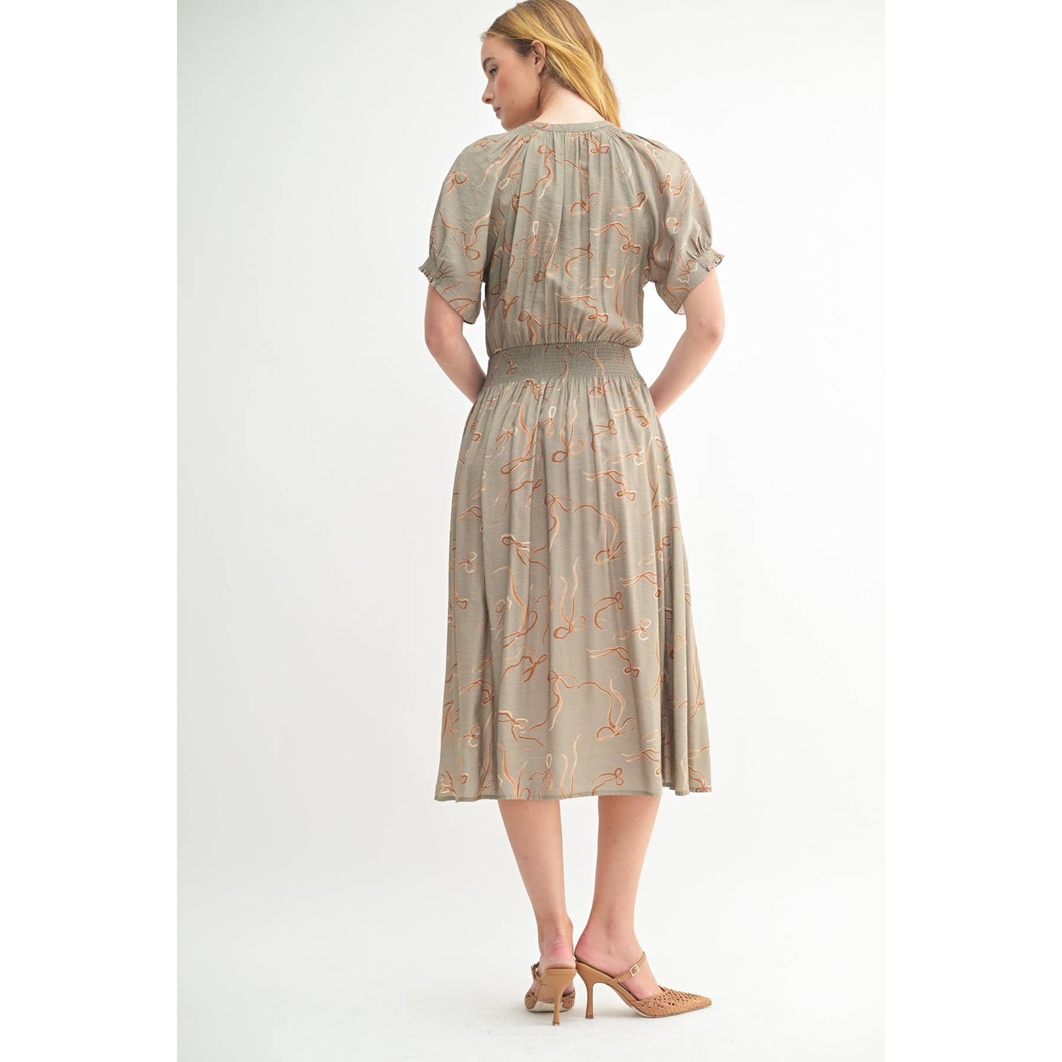 Back view of the Isolde Midi Dress revealing the relaxed fit and fluid midi-length silhouette.