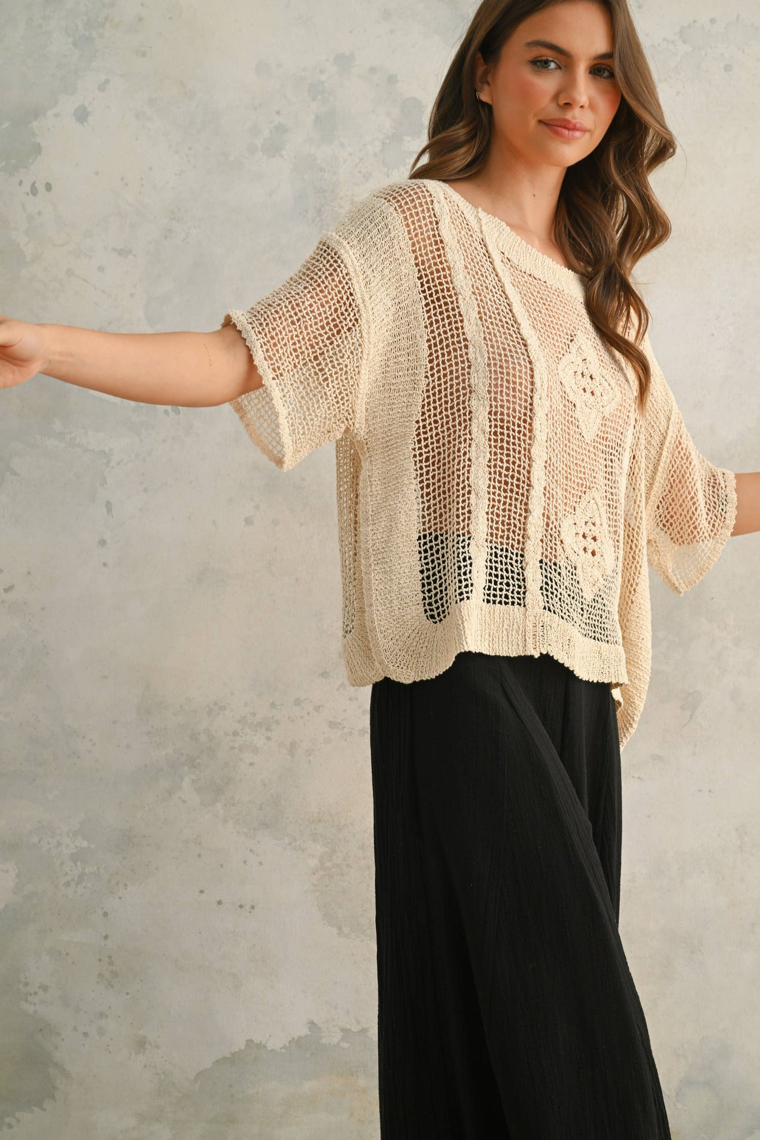 Side view capturing the relaxed fit and soft drape of the lightweight crochet knit.