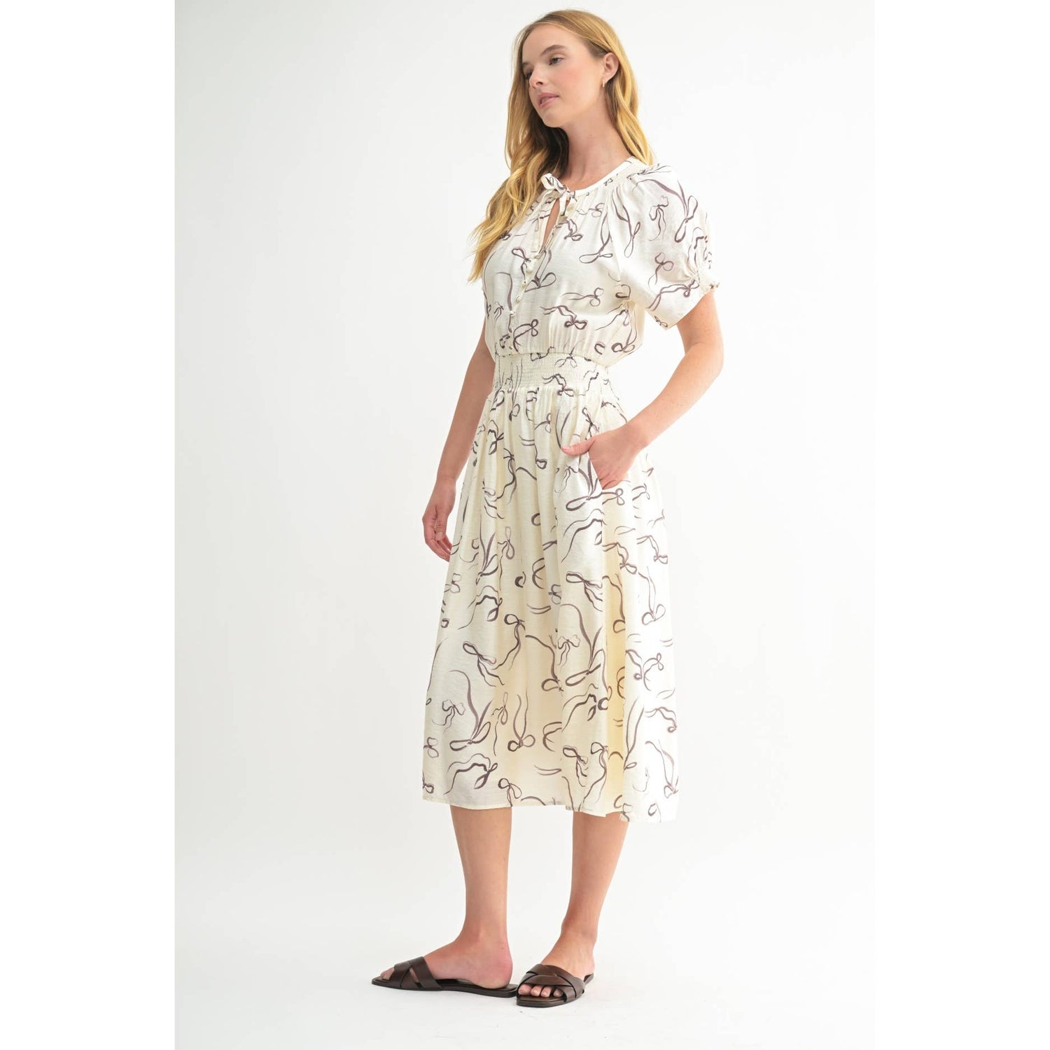 Side view of the Isolde Midi Dress showing the elegant drape and elongated silhouette.