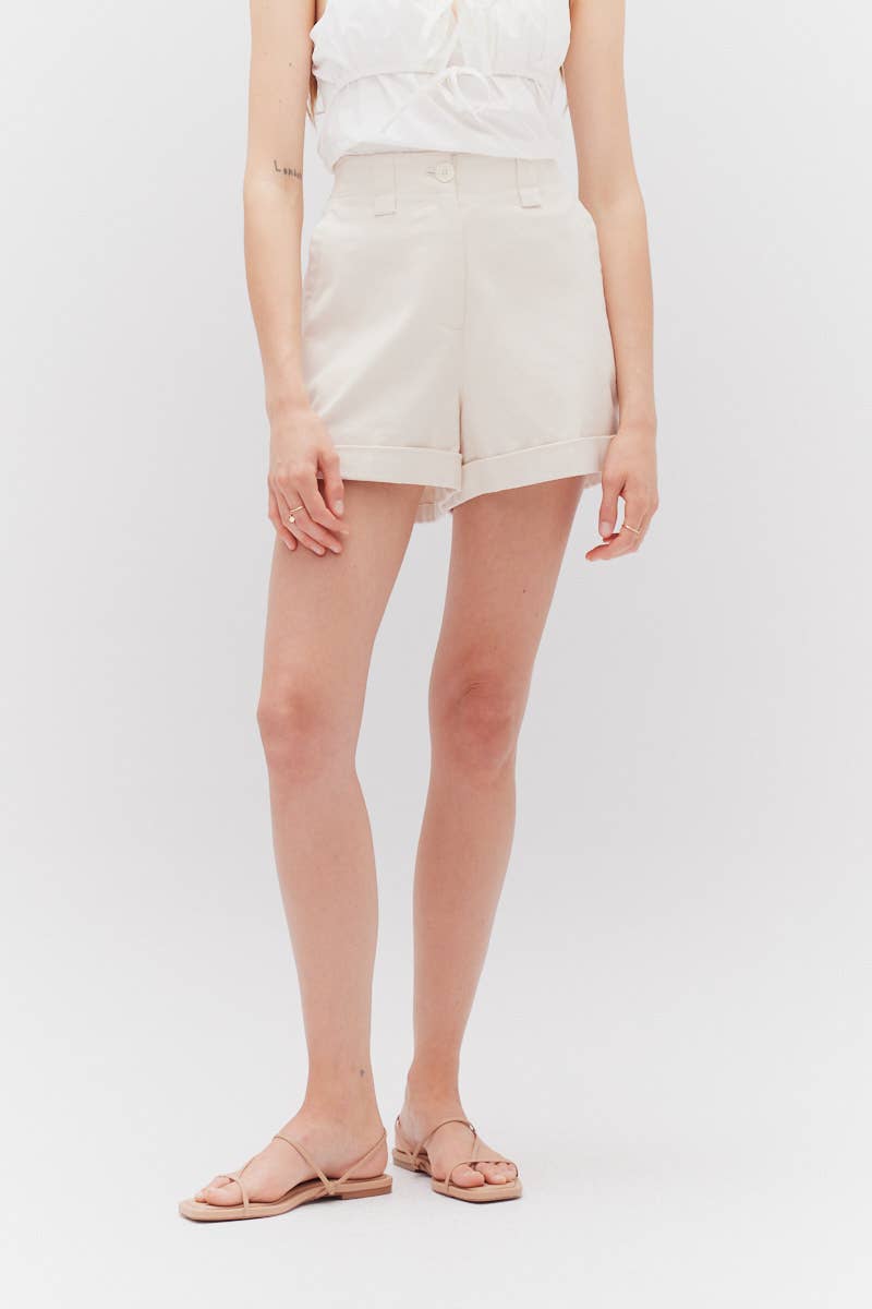 The Milk Twill Shorts feature cuffs and button zip closure