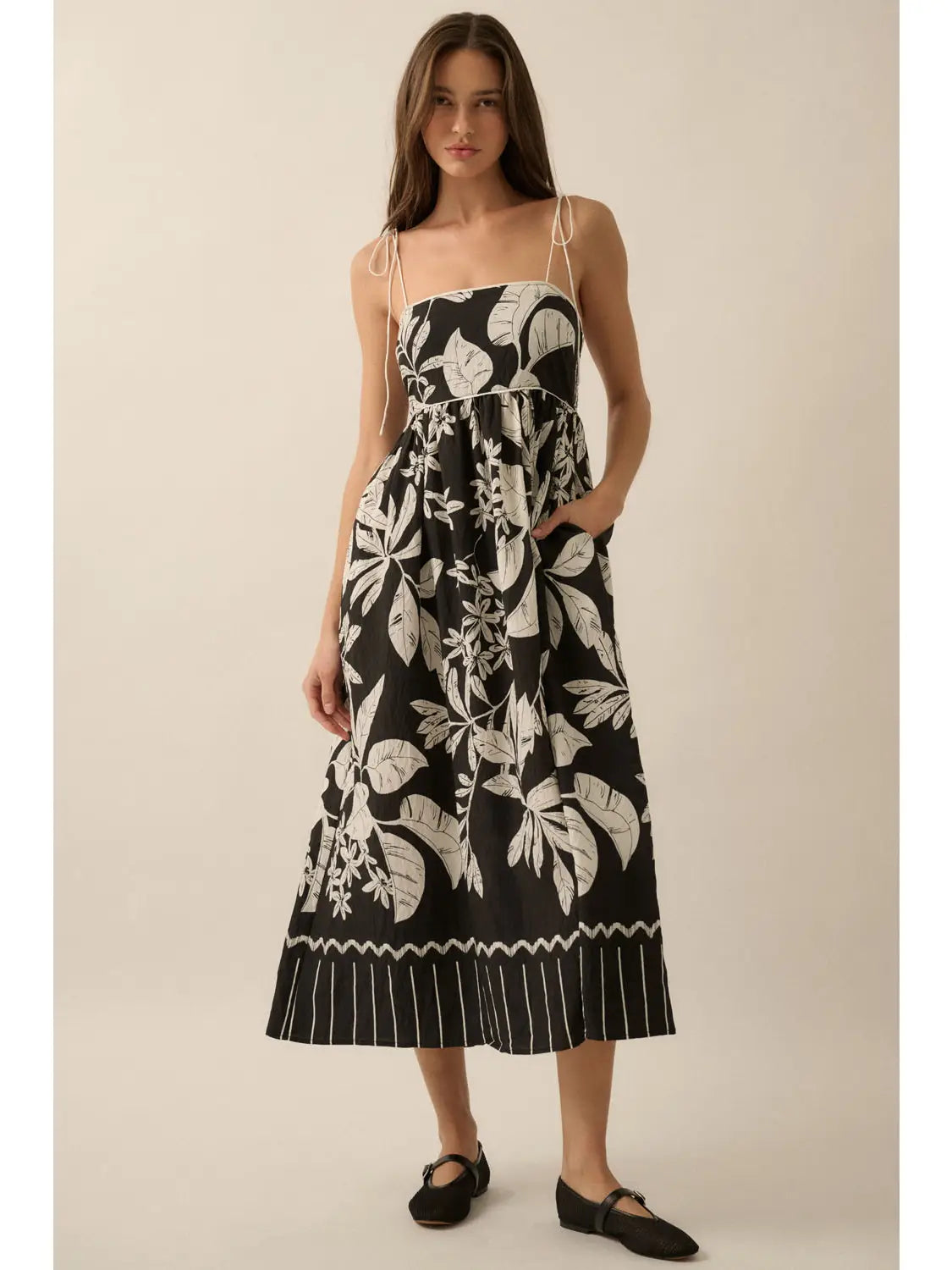 Woman wearing a black floral dress on a white background