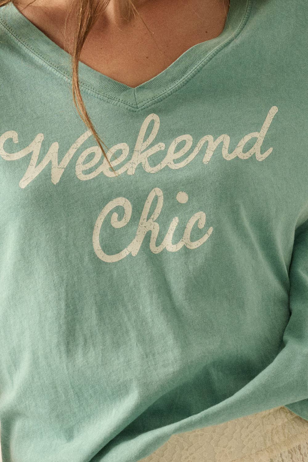 Close-up detail of Veyra Graphic Tee featuring mineral-wash cotton fabric and “Weekend Chic” graphic print