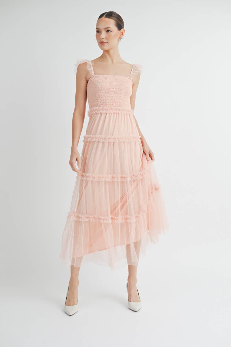 Model wearing blush pink Clovette Midi Dress styled for a wedding guest look