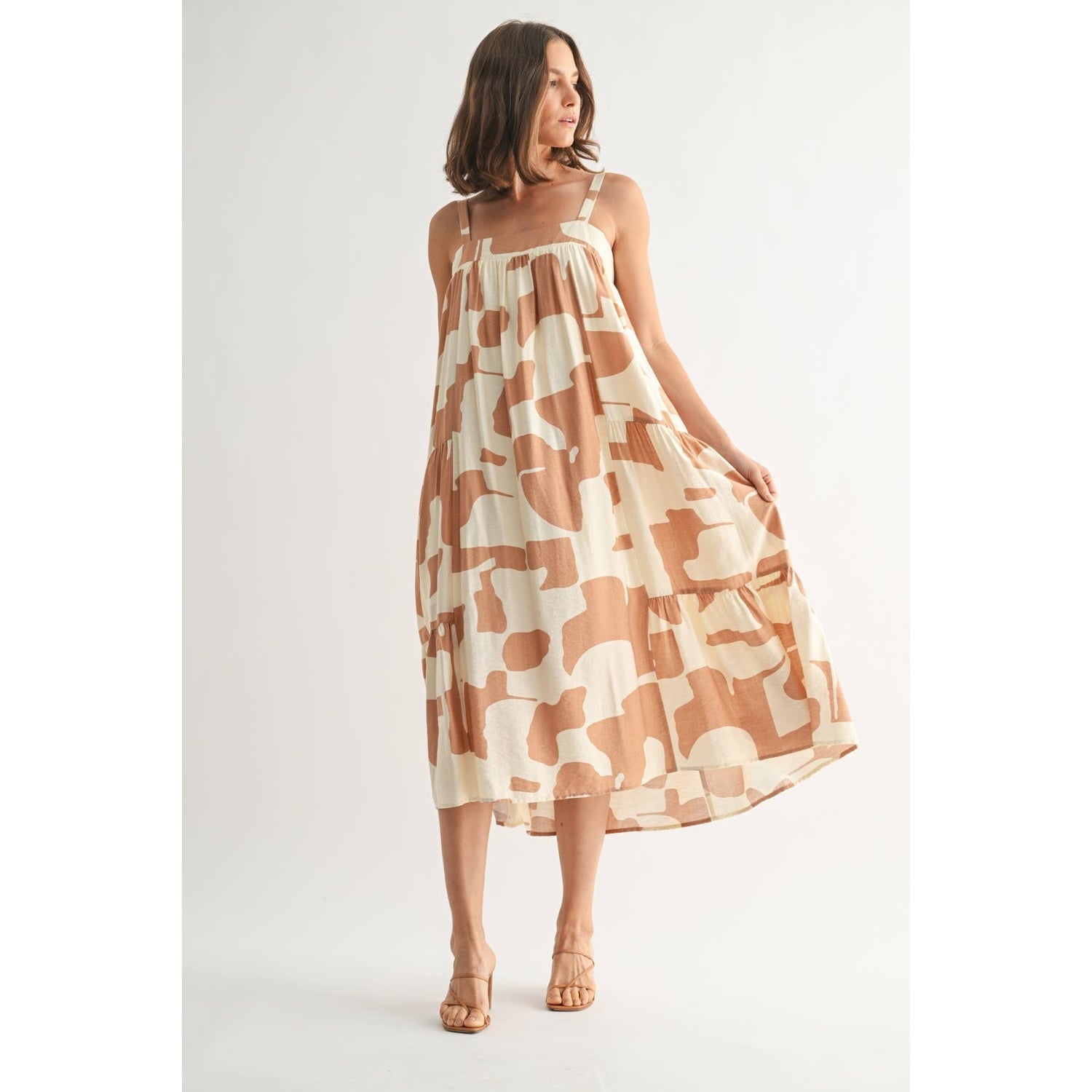 Front angled view of the Elowen Midi Dress highlighting the flowing tiers and elegant midi length.