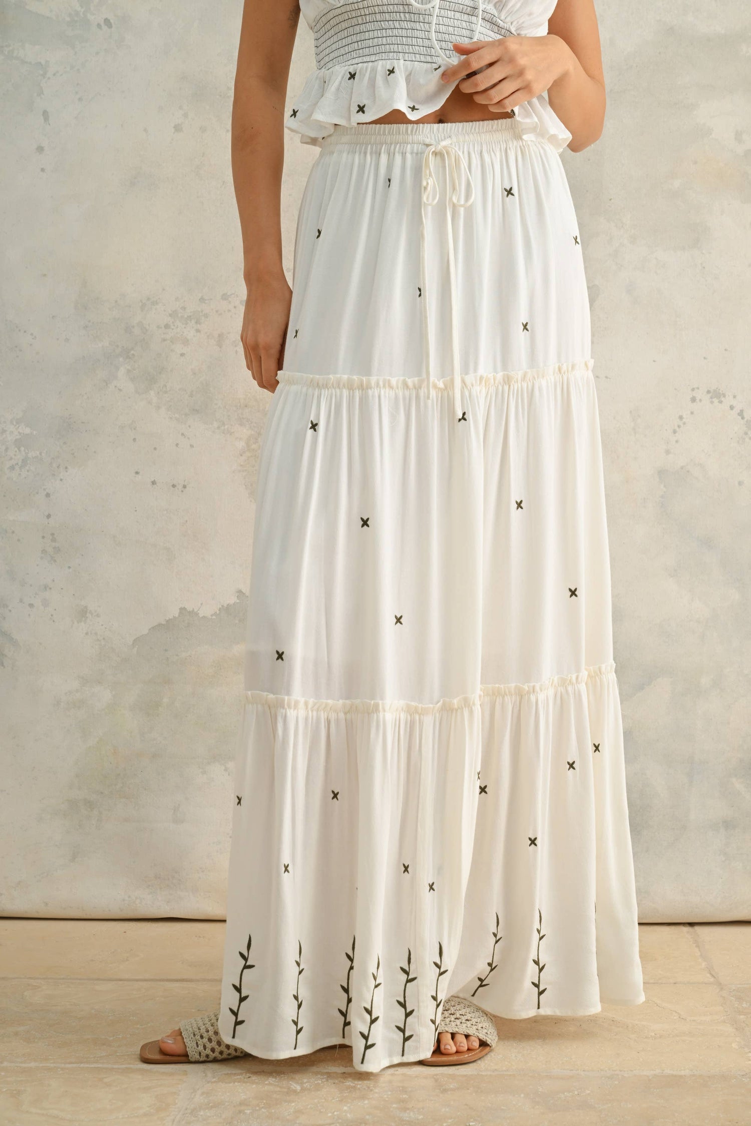 Front view styled with the matching smocked top, highlighting the coordinated embroidered set.