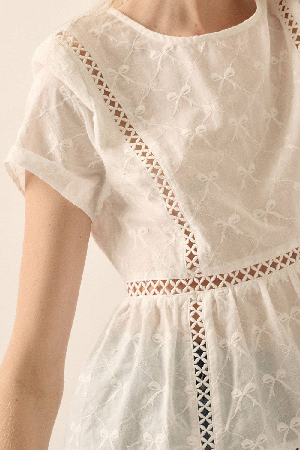 Off White Bow-Embroidered Lace-Trim Ruffled Babydoll Top close up view of embroidered detail and bow pattern