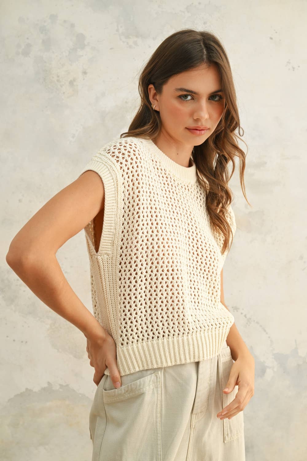 Side angle focusing on the intricate open-knit design and relaxed fit.