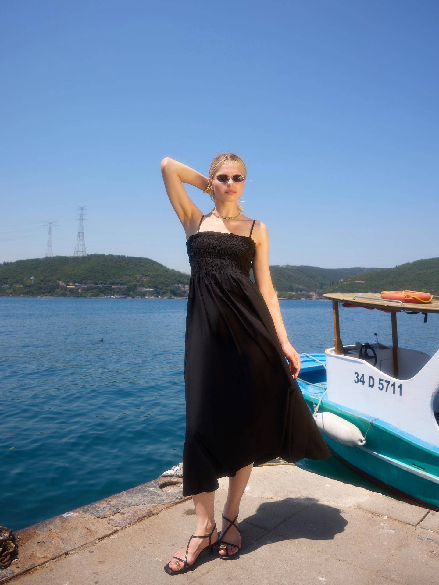 The Black Guipé Strap Maxi Dress showcasing fitted bodice and flared skirt