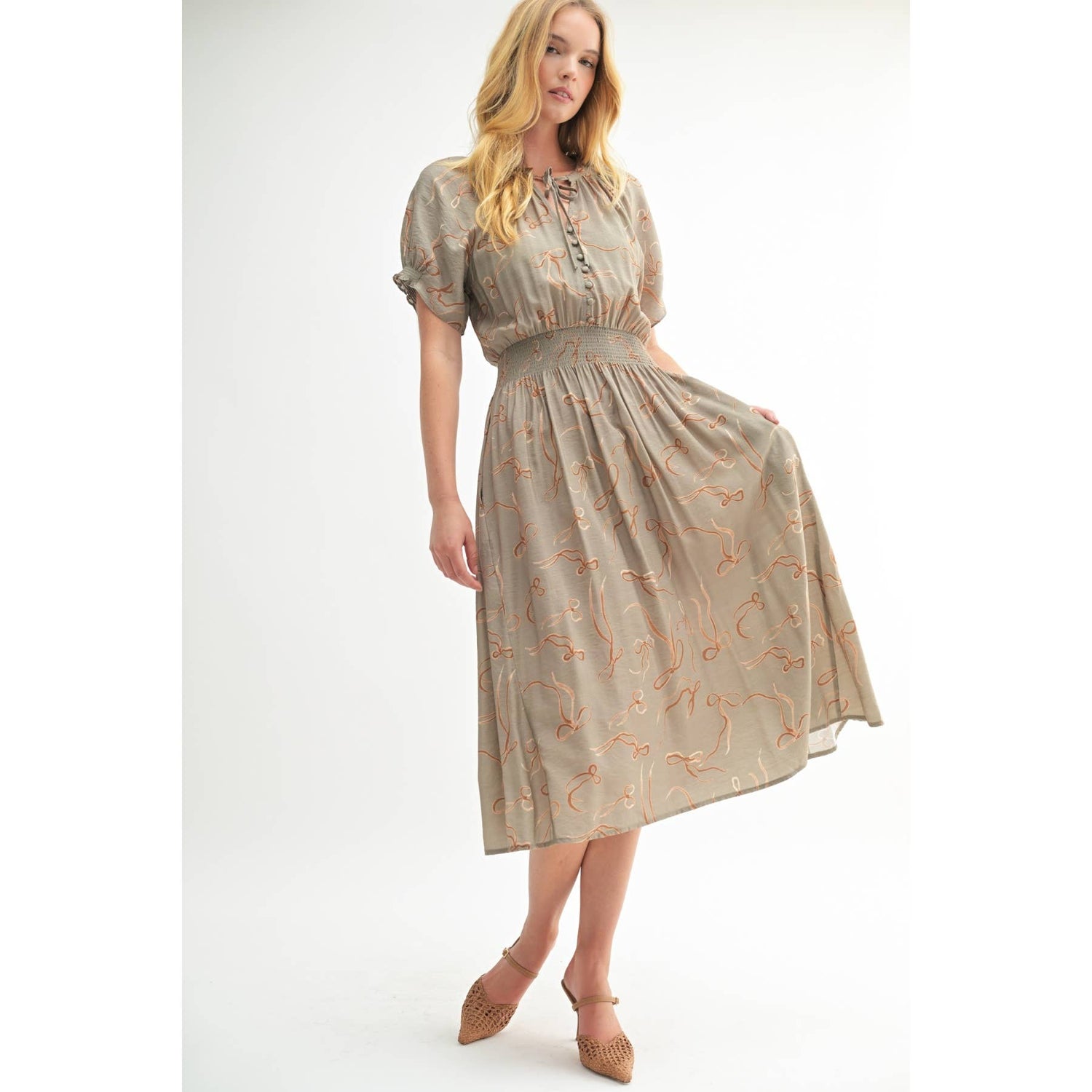 Third front view of the Isolde Midi Dress showing the soft sage tone and elegant, elongated shape.